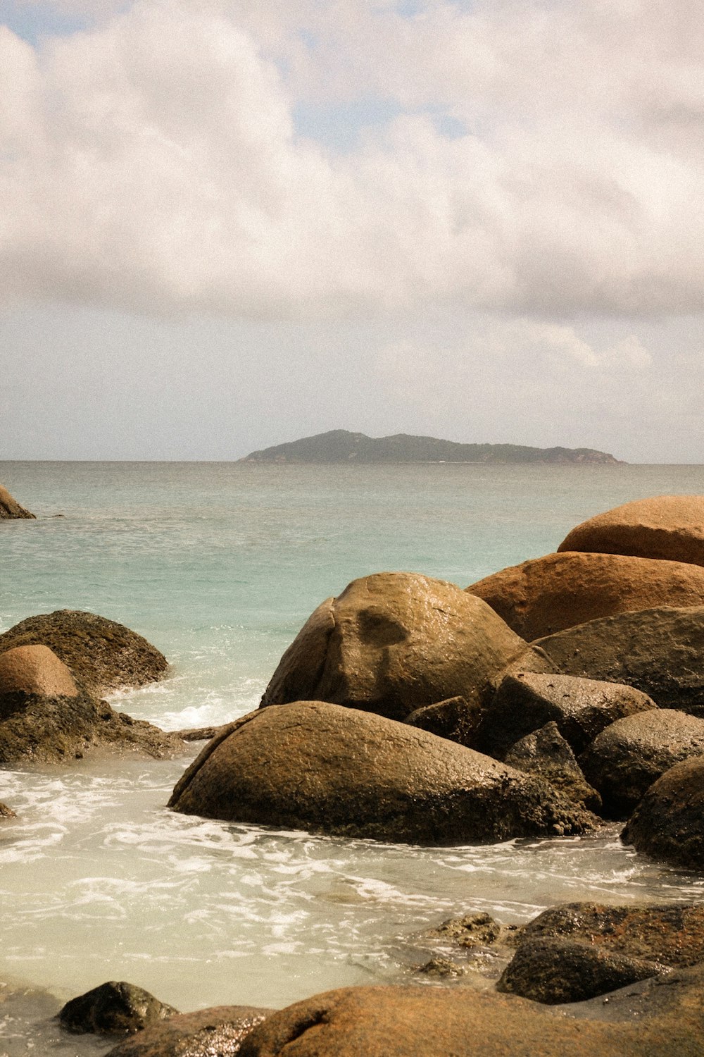 brown rock formation on sea during daytime