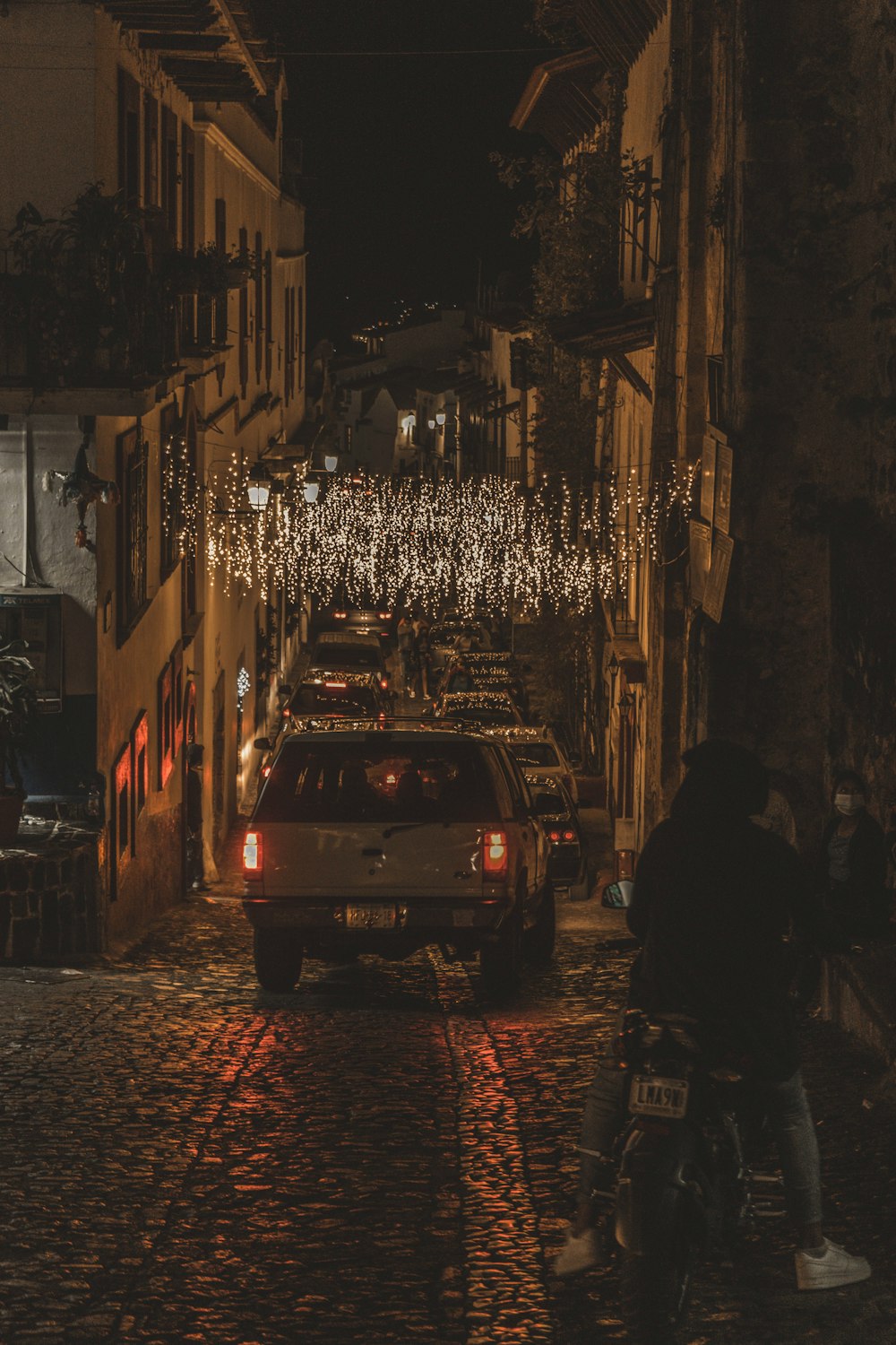 people walking on street during night time