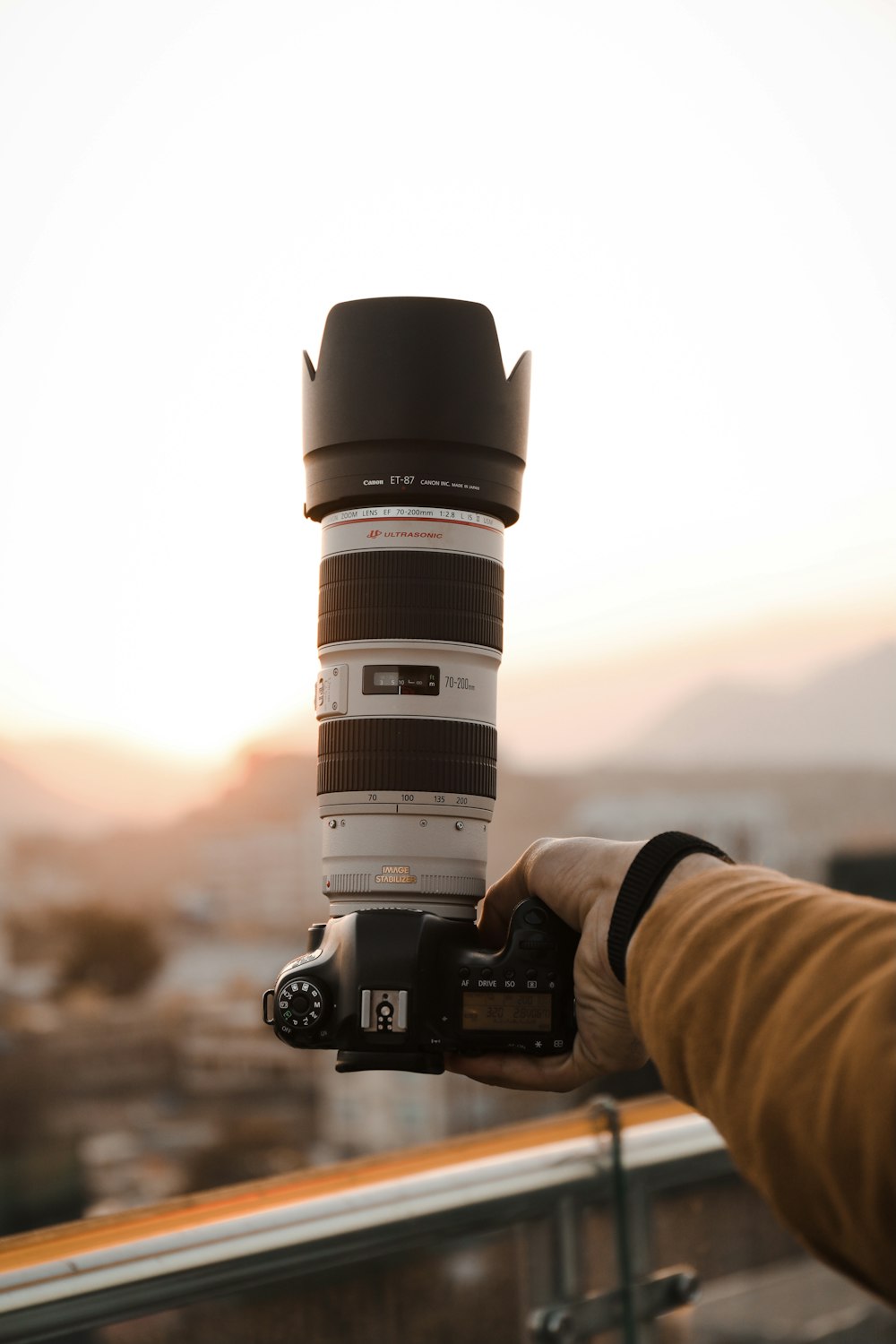 person holding black and white dslr camera