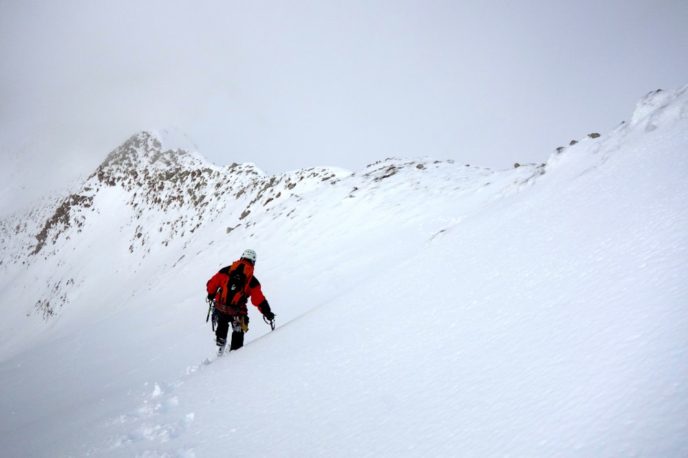 2 person walking on snow covered ground during daytime