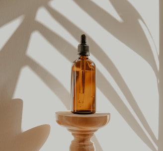 clear glass bottle on white wooden round table