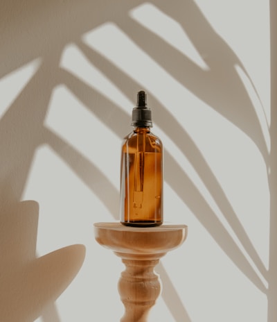 clear glass bottle on white wooden round table