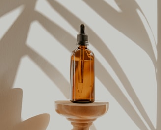 clear glass bottle on white wooden round table