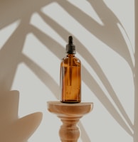 clear glass bottle on white wooden round table