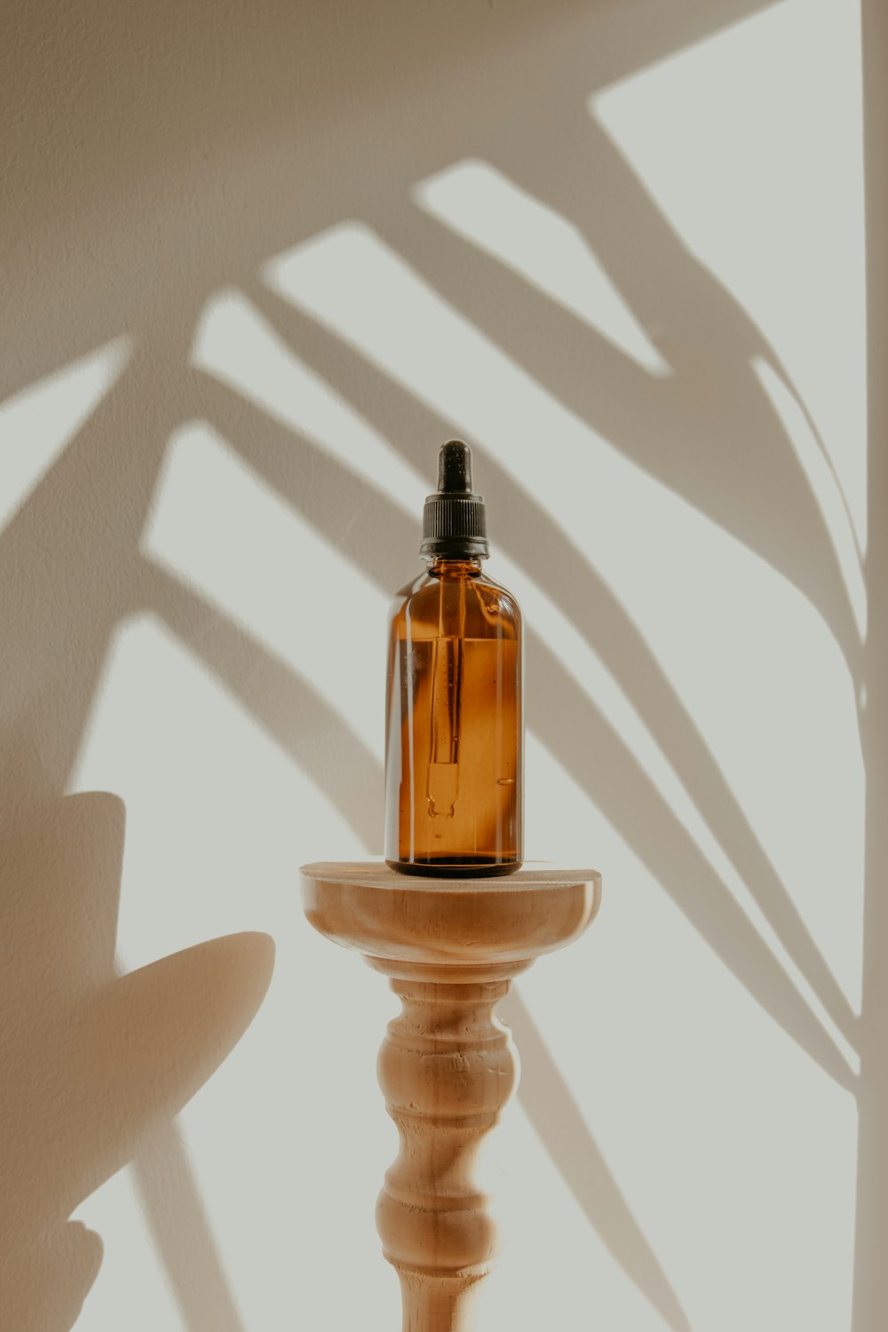 clear glass bottle on white wooden round table