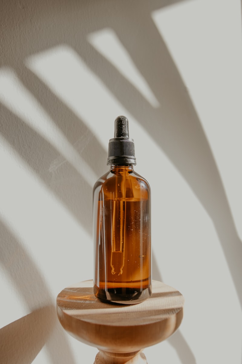 Clear glass oil bottle with orange liquid