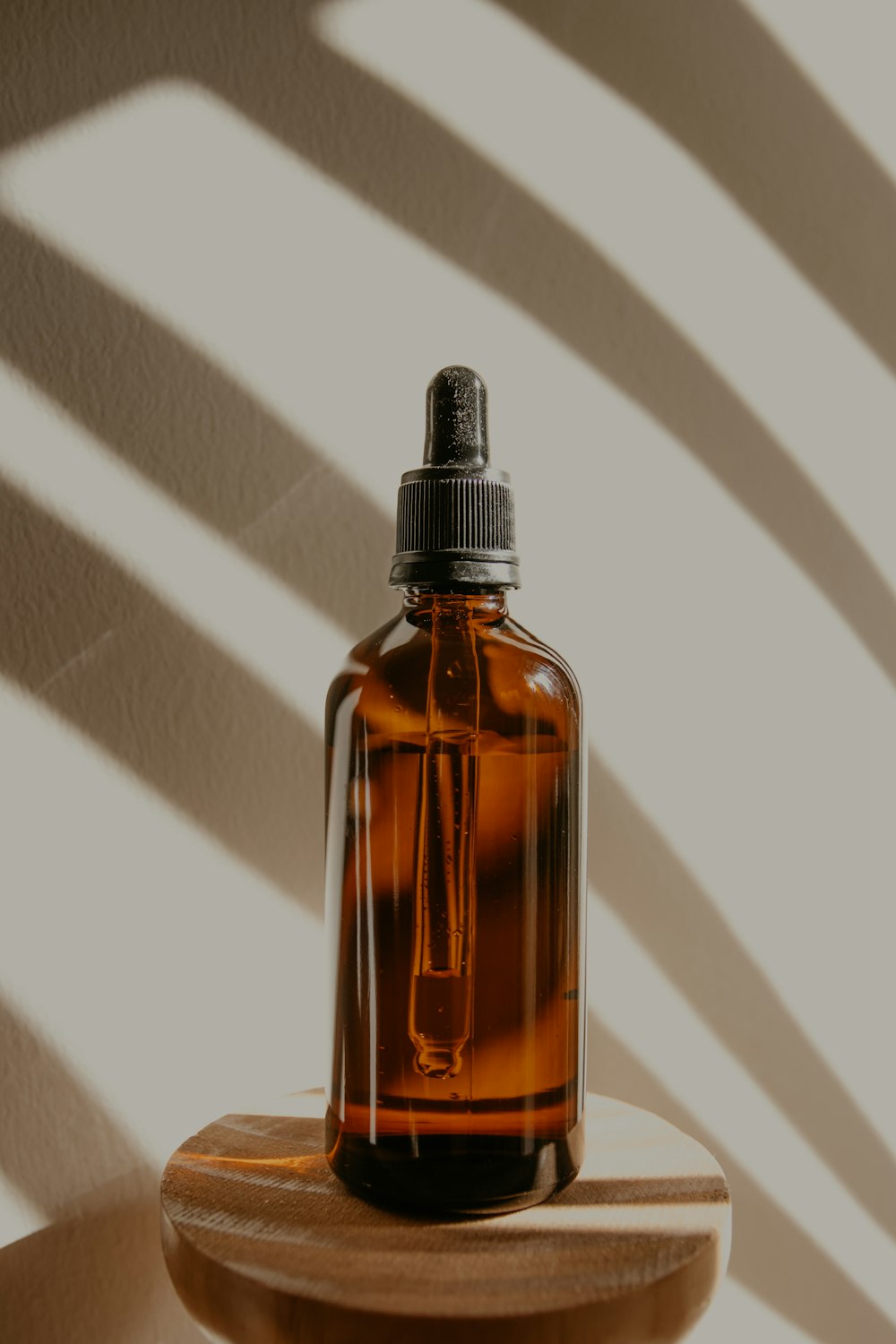 brown glass bottle on white table