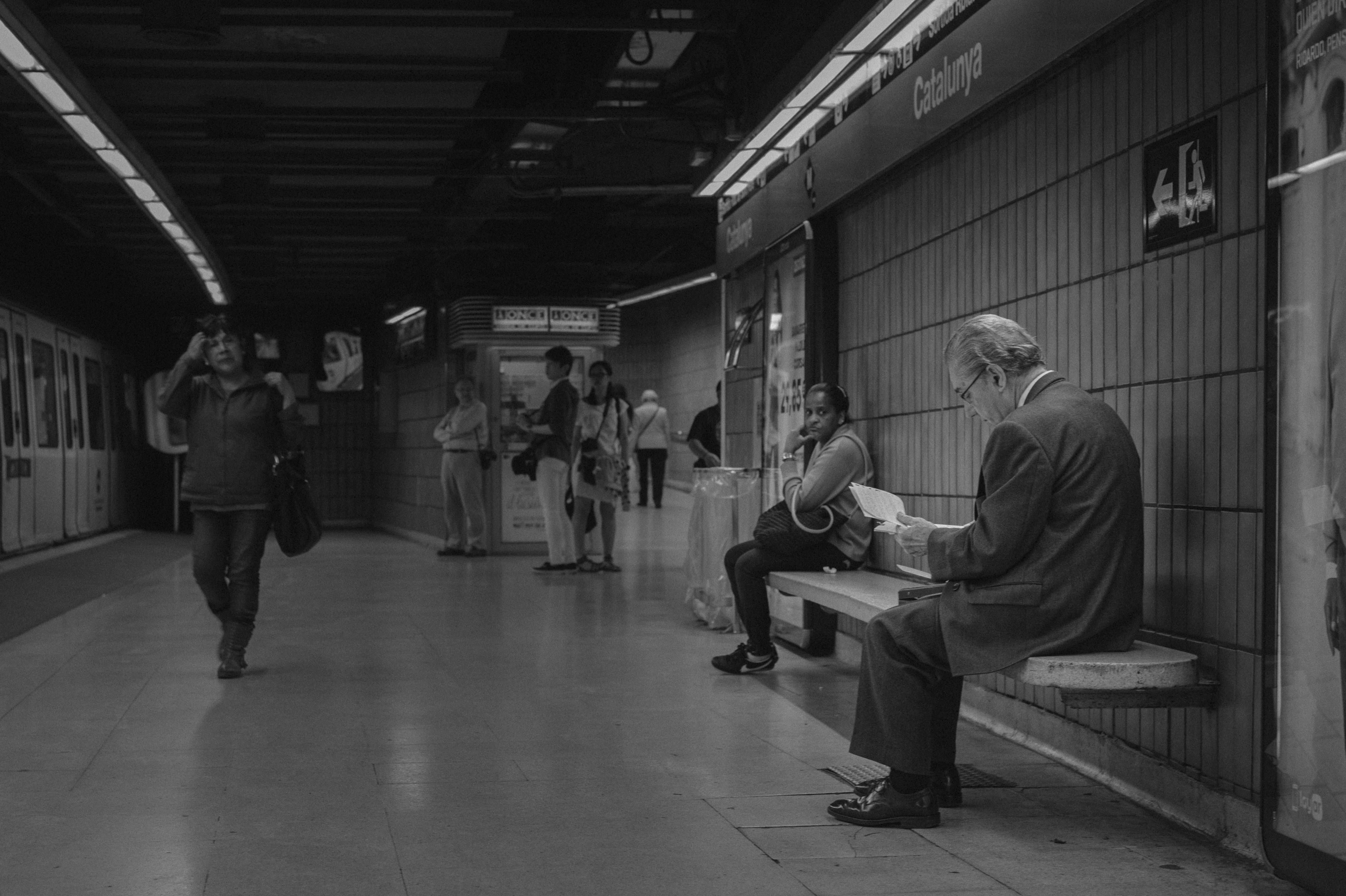 Man sits on a bench in the subway.