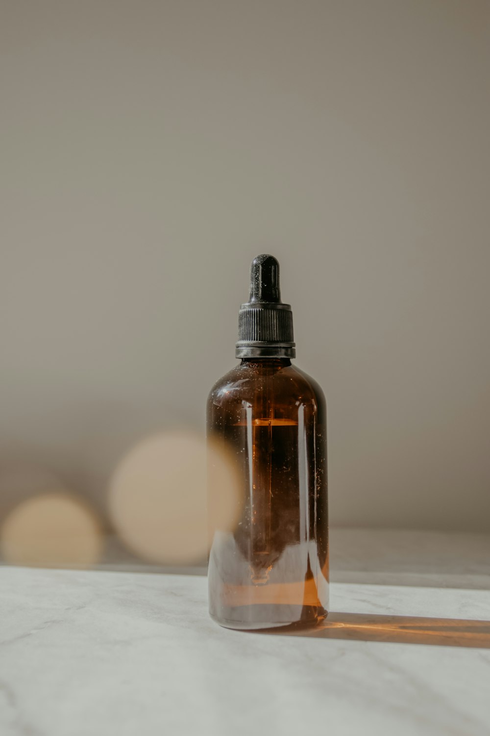 clear glass bottle with brown liquid