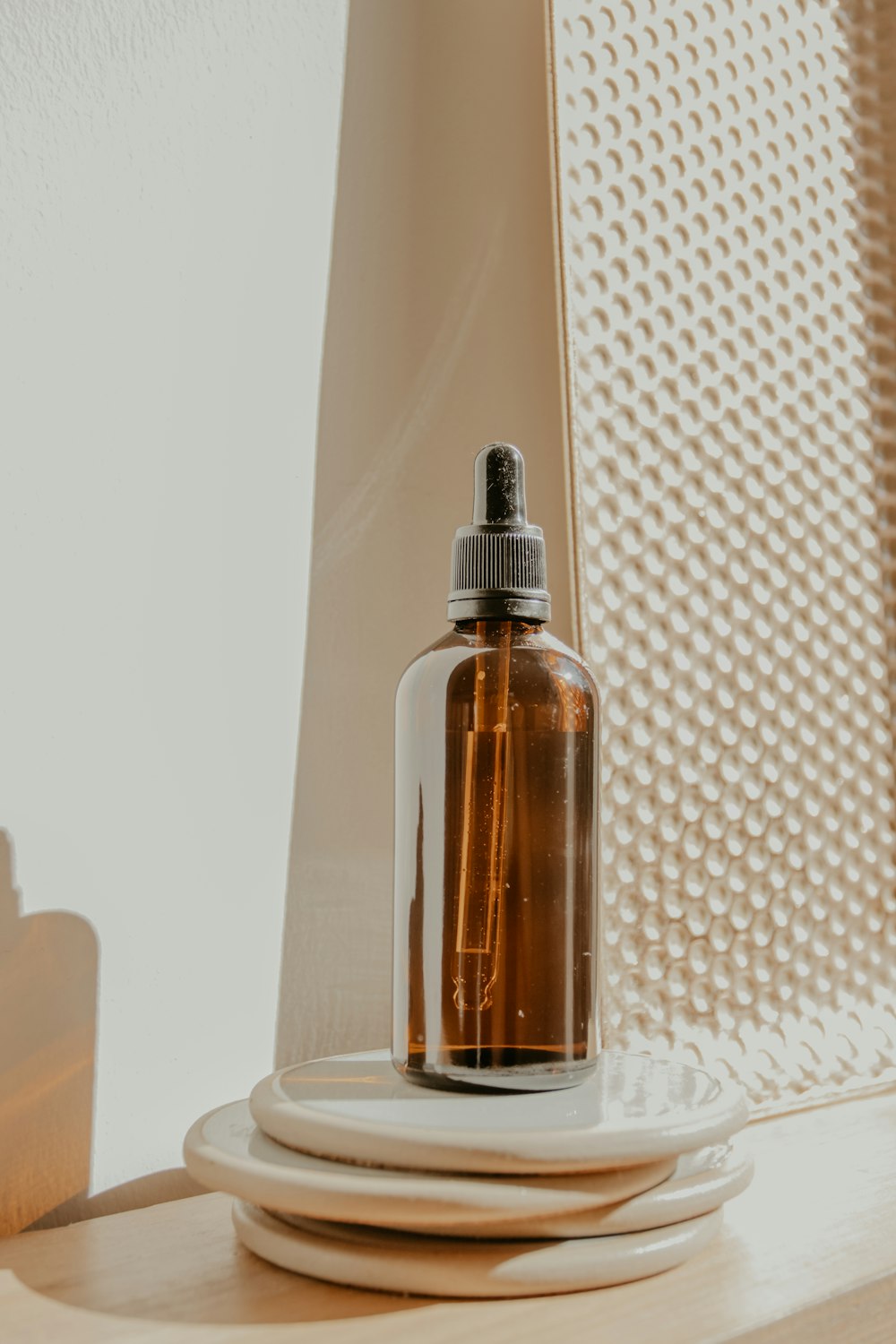 clear glass bottle on white table