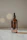 Close-up of a stylish essential oil bottle with soft warm lighting