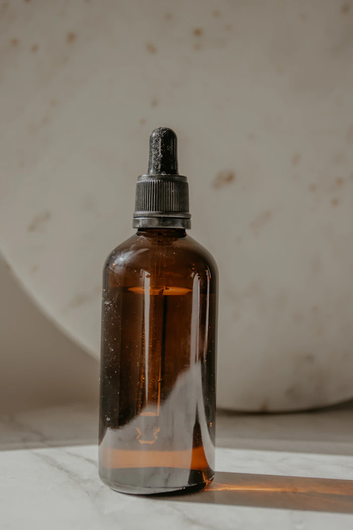 A brown glass bottle on a white table