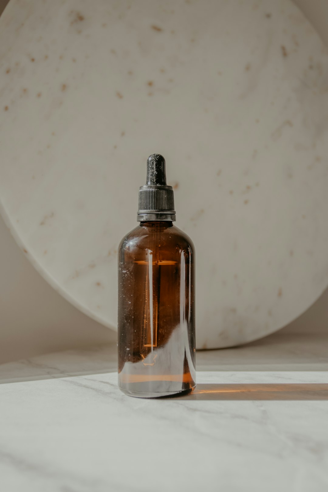 clear glass bottle on white table