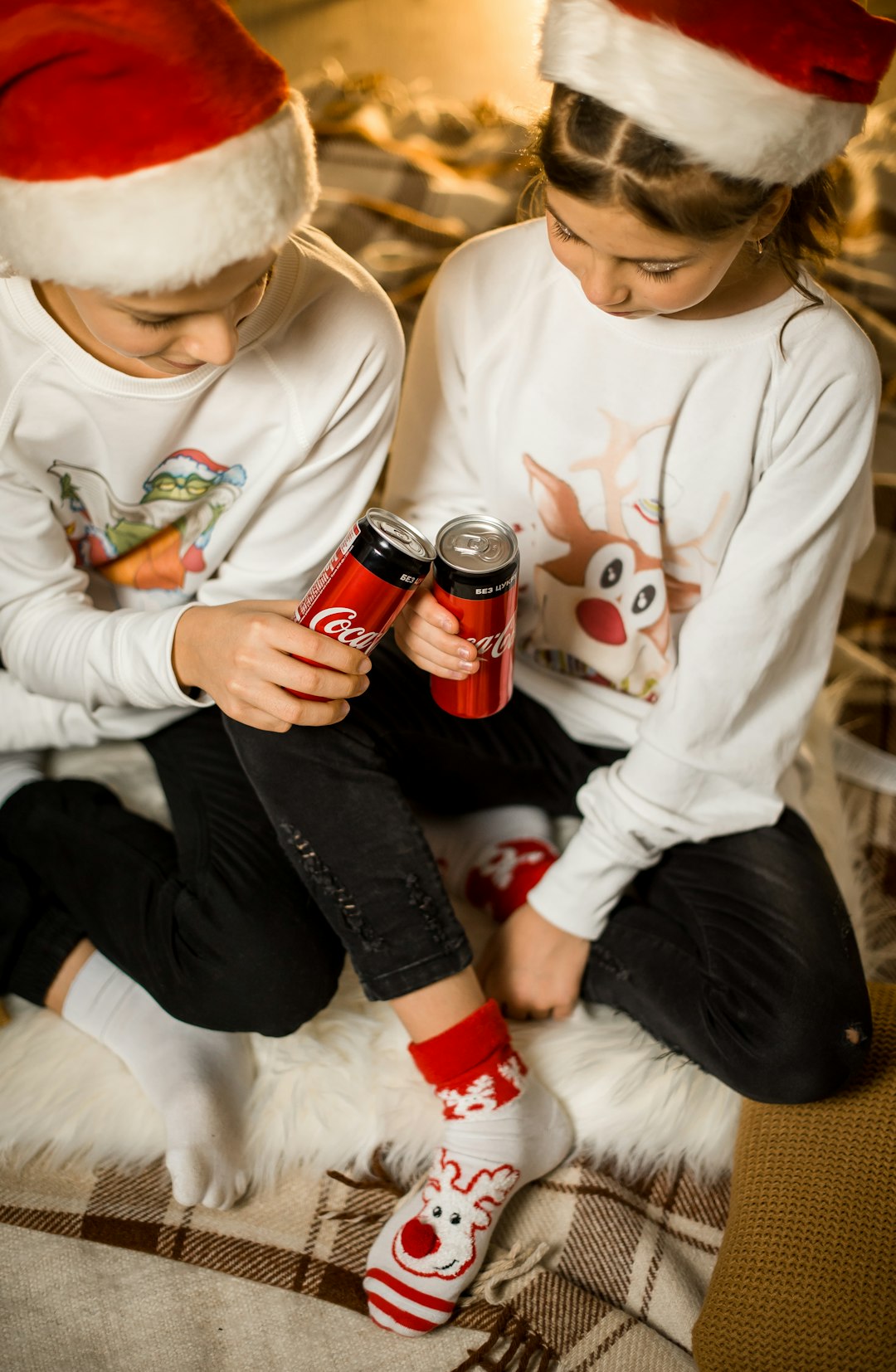 boy in white long sleeve shirt holding coca cola can