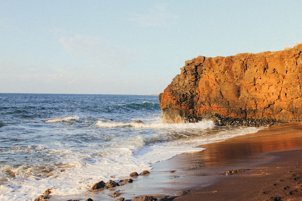 brown rock formation on sea shore during daytime