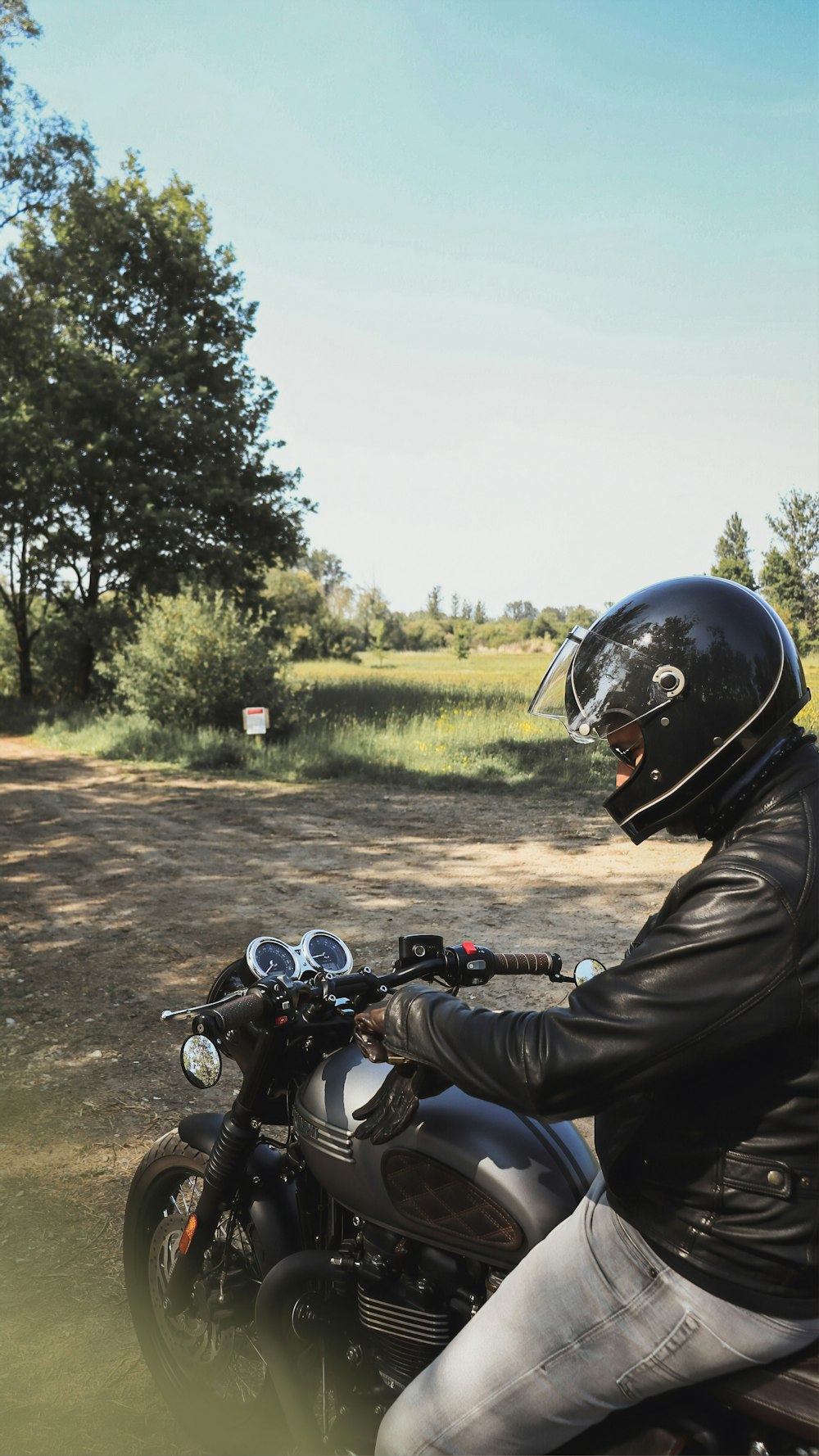 man in black jacket riding motorcycle during daytime