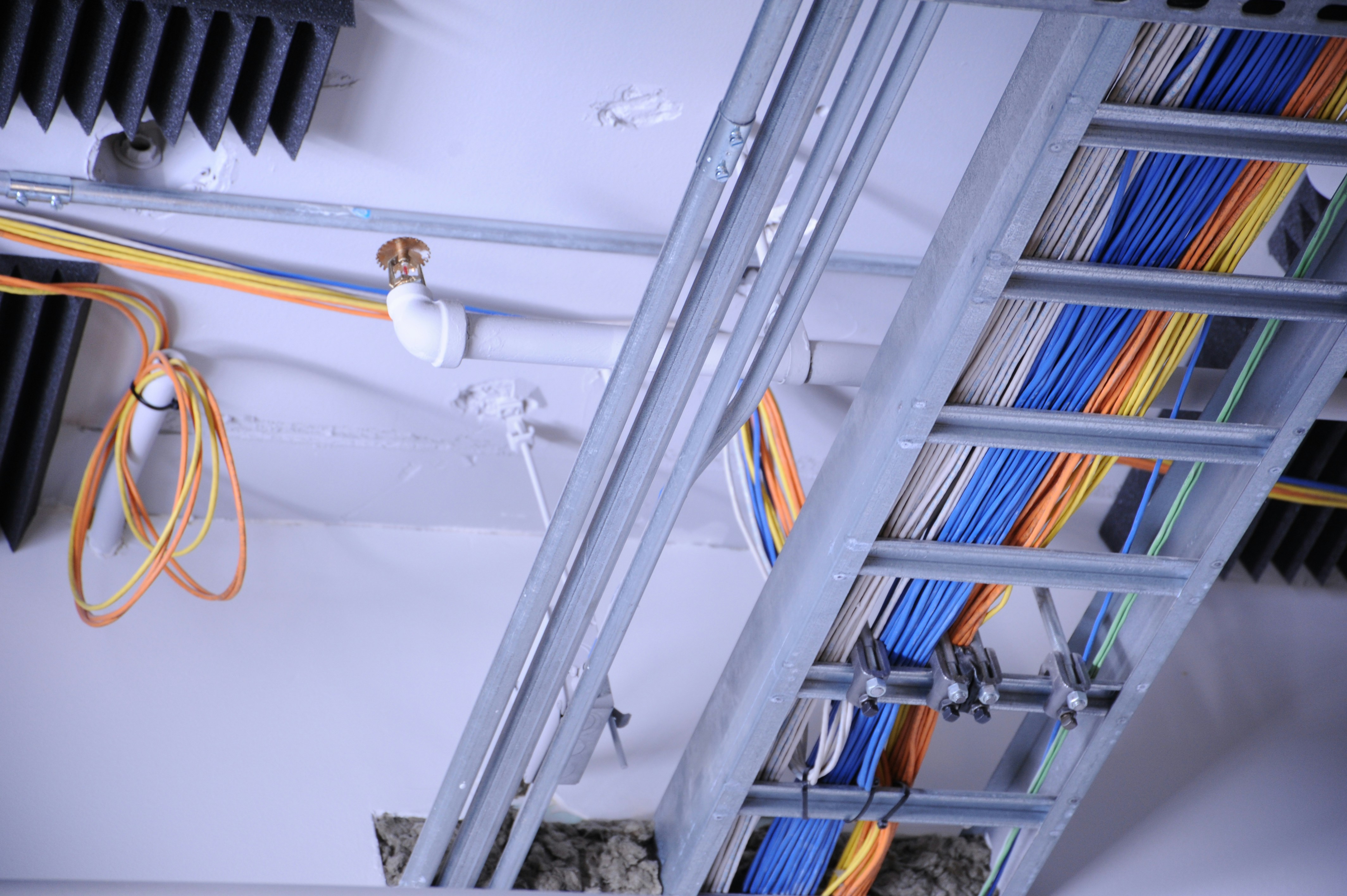 Organized wiring and cabling running along a ceiling and rafters