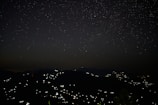 Night sky over Fiji, stars twinkling above a quiet village.