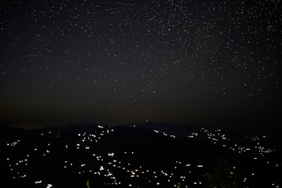 Night sky over Fiji, stars twinkling above a quiet village.