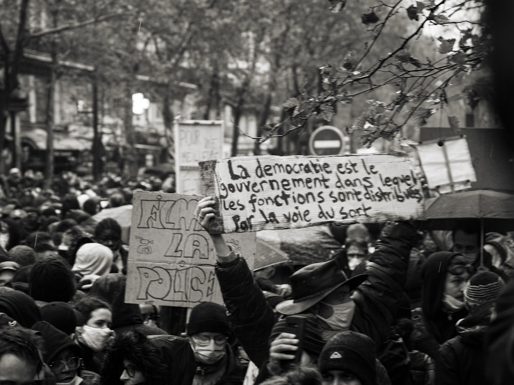 people holding white and blue banner