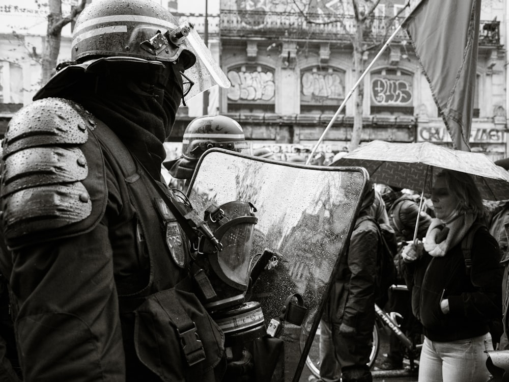 grayscale photo of people in black uniform