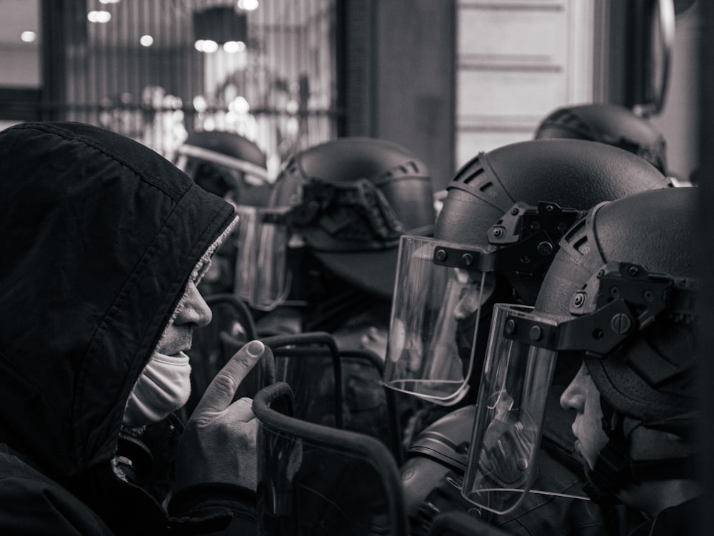 grayscale photo of motorcycle helmet and helmet