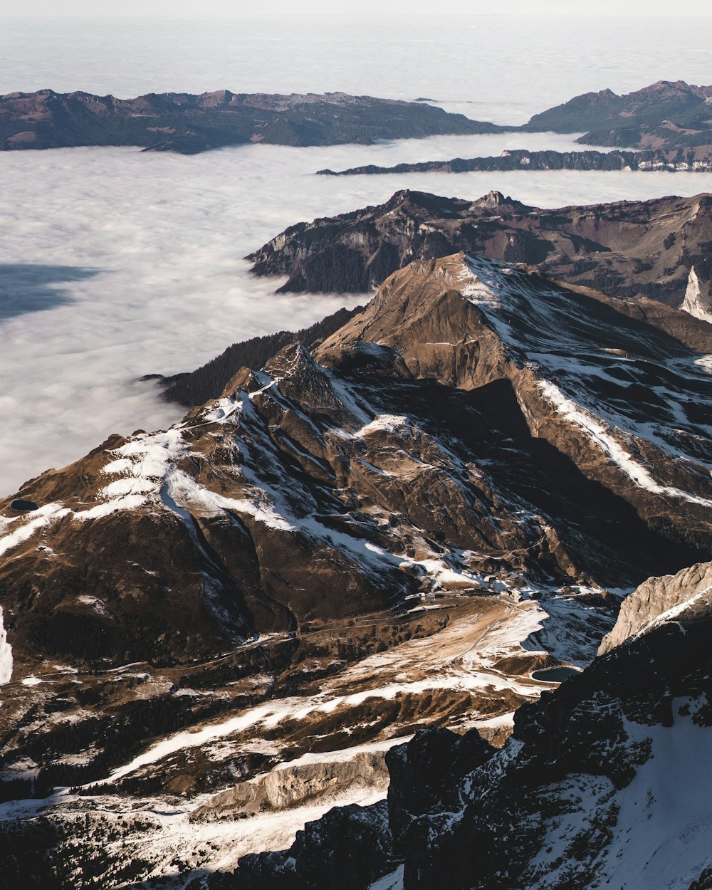 brown and white mountains near body of water during daytime