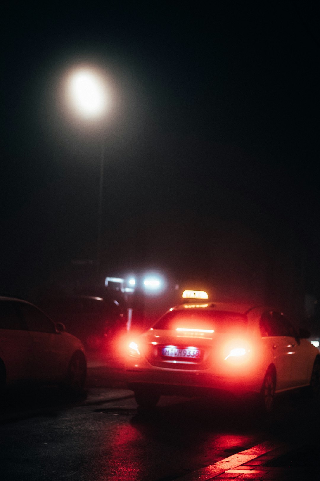 red car on road during night time