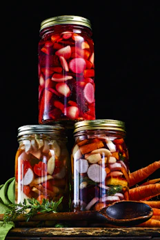 Colorful mixed vegetable pickle showcasing carrots, cauliflower, and green beans.