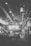 A large industrial workshop with high ceilings, exposed beams, and a variety of machinery. A clock is visible on the right side, indicating the time. There are overhead lights and large windows letting in natural light, with a few workers visible in the background.
