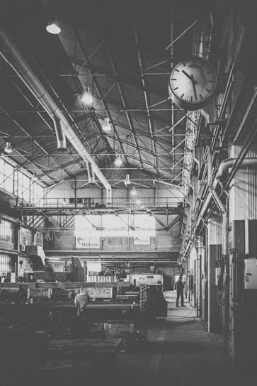 A sleek, modern workshop interior with advanced machinery and craftsmen at work.