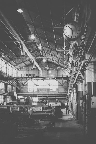Wide shot of a modern industrial workshop with various automated machines in operation.