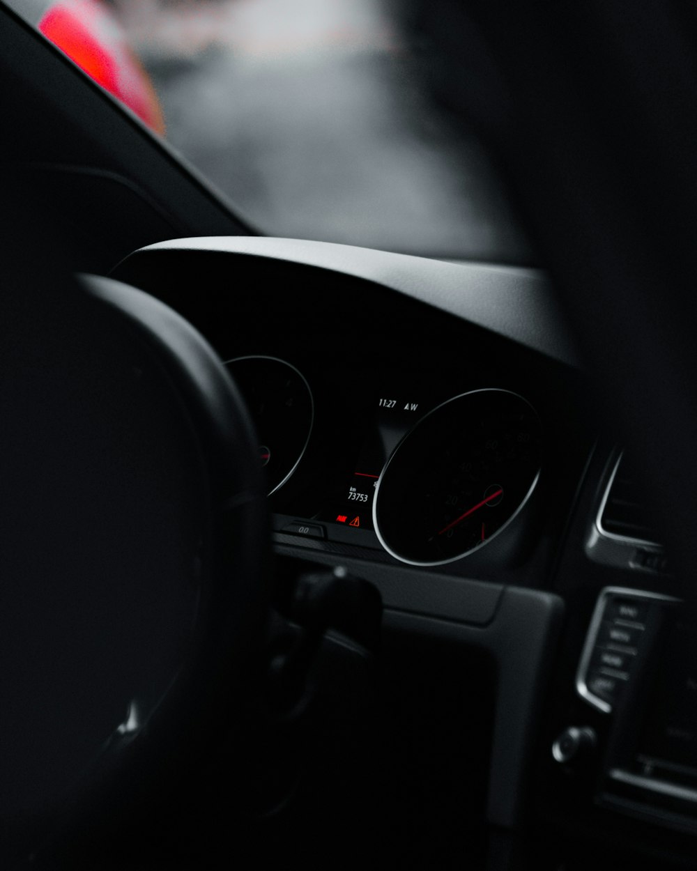 black car steering wheel in tilt shift lens