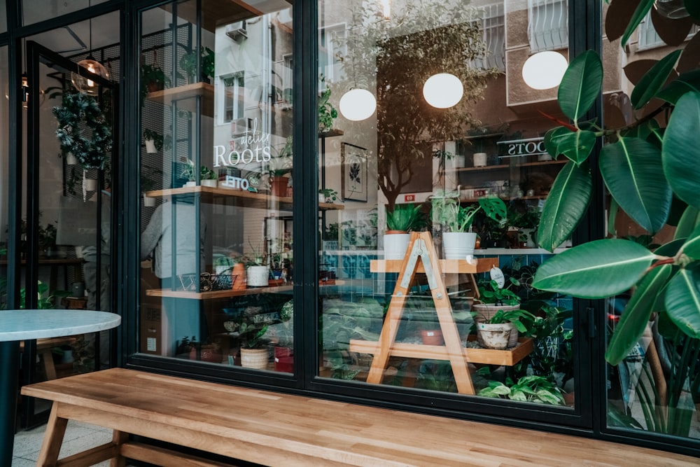 brown wooden chair beside glass window