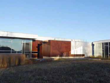 Wide shot of a commercial building with a newly installed flat roof featuring durable materials.