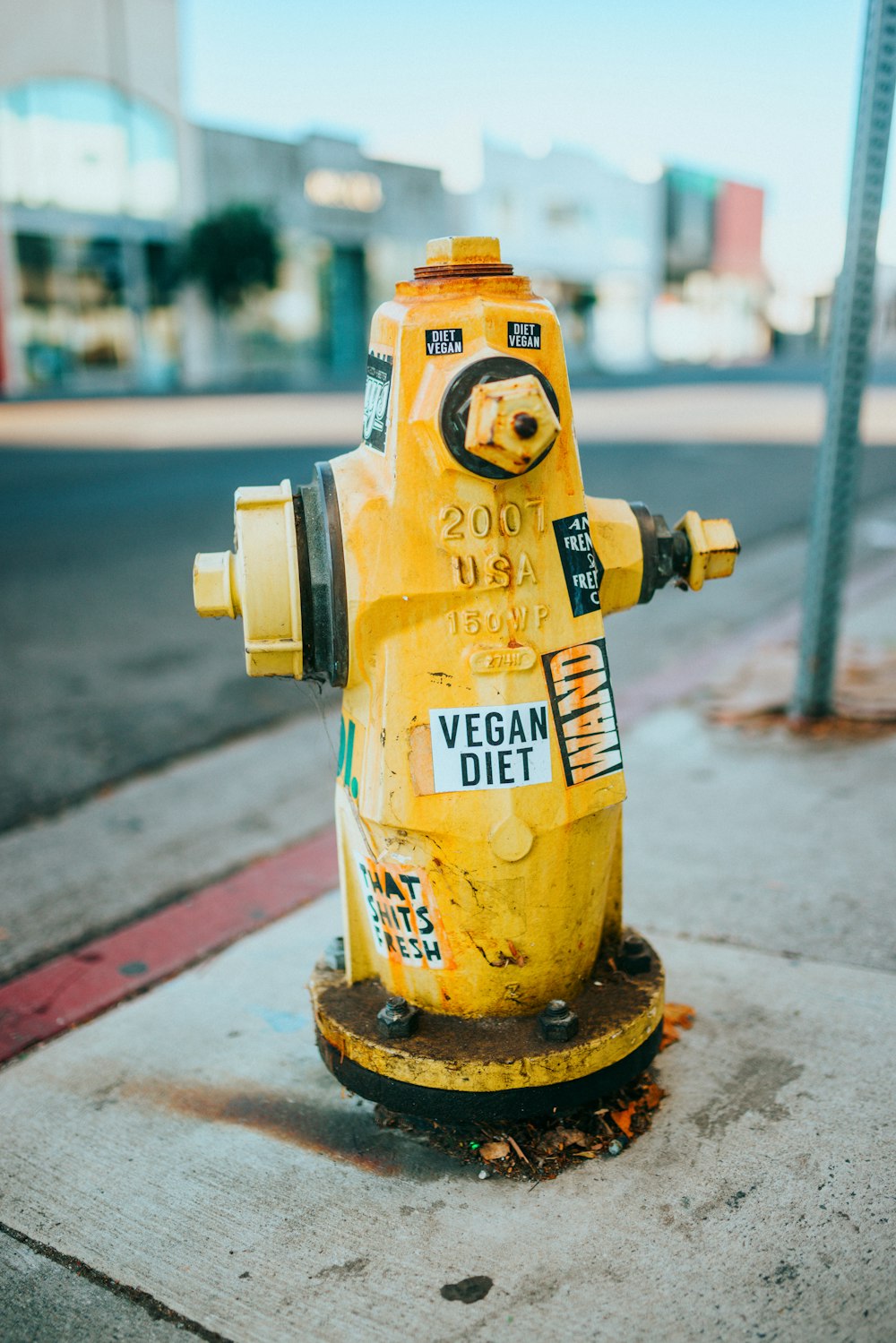 日中の灰色のコンクリート道路の黄色い消火栓