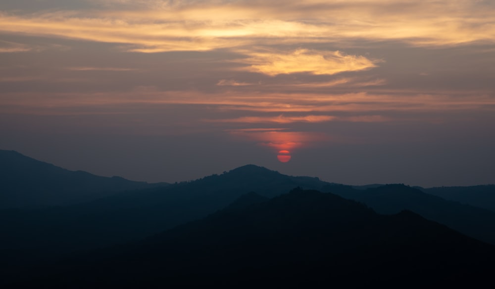 silhouette of mountains during sunset