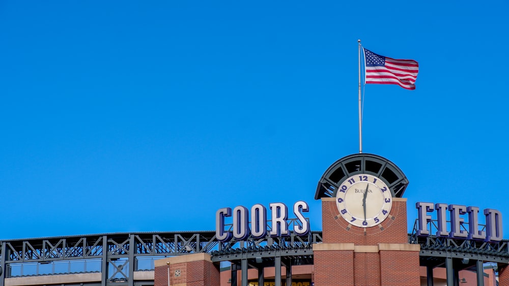 a clock tower with a flag on top of it