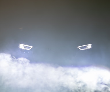 white and black plane on mid air under gray clouds