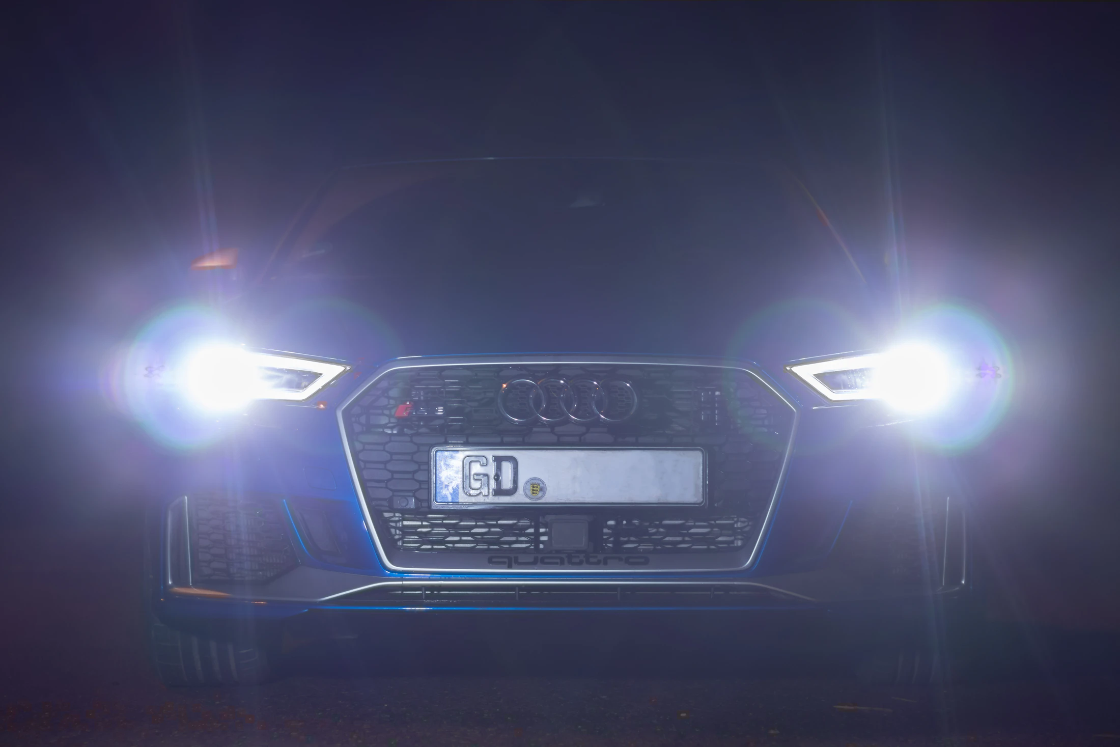 Audi RS 3 at night with LED headlights blazing
