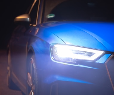 blue car on black asphalt road during night time