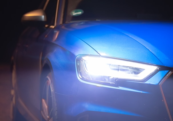 blue car on black asphalt road during night time