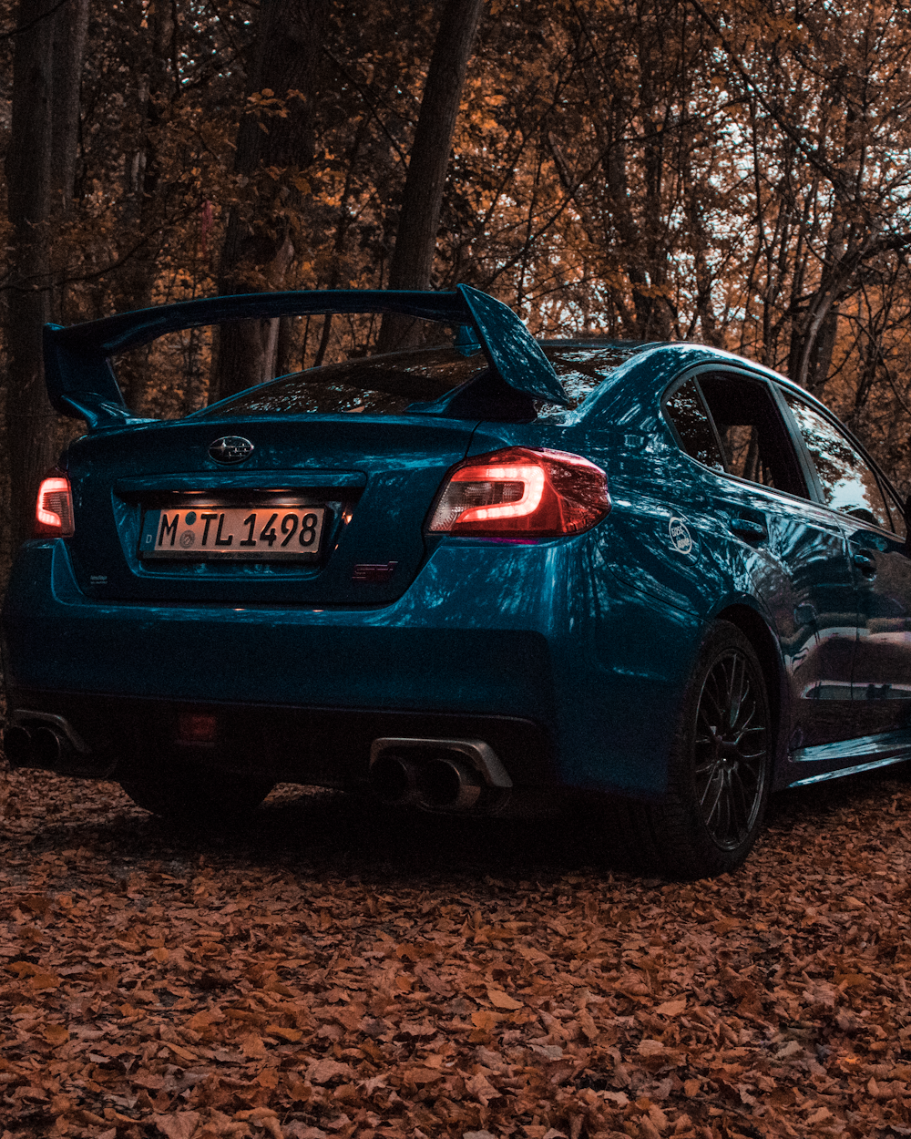 blue audi r 8 parked near brown trees during daytime