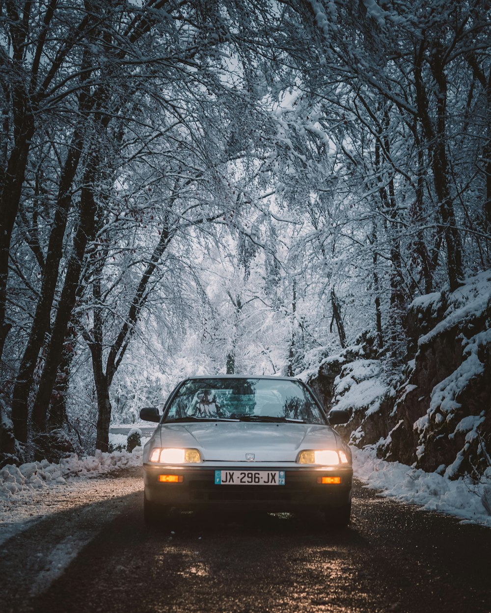 black car on snow covered road