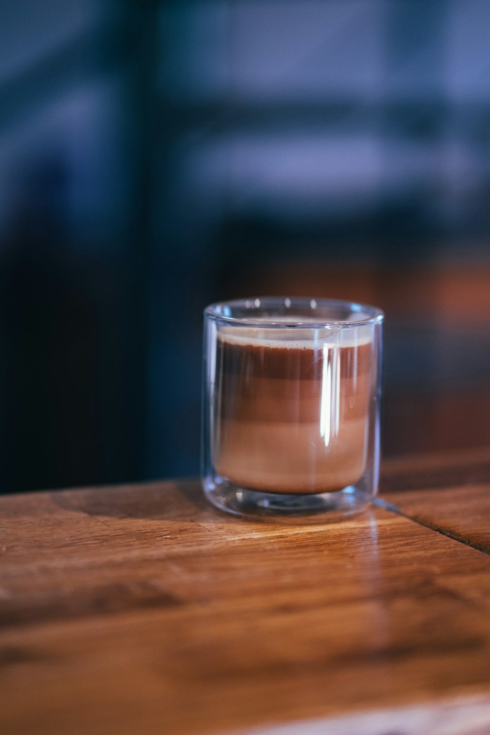 clear drinking glass on brown wooden table