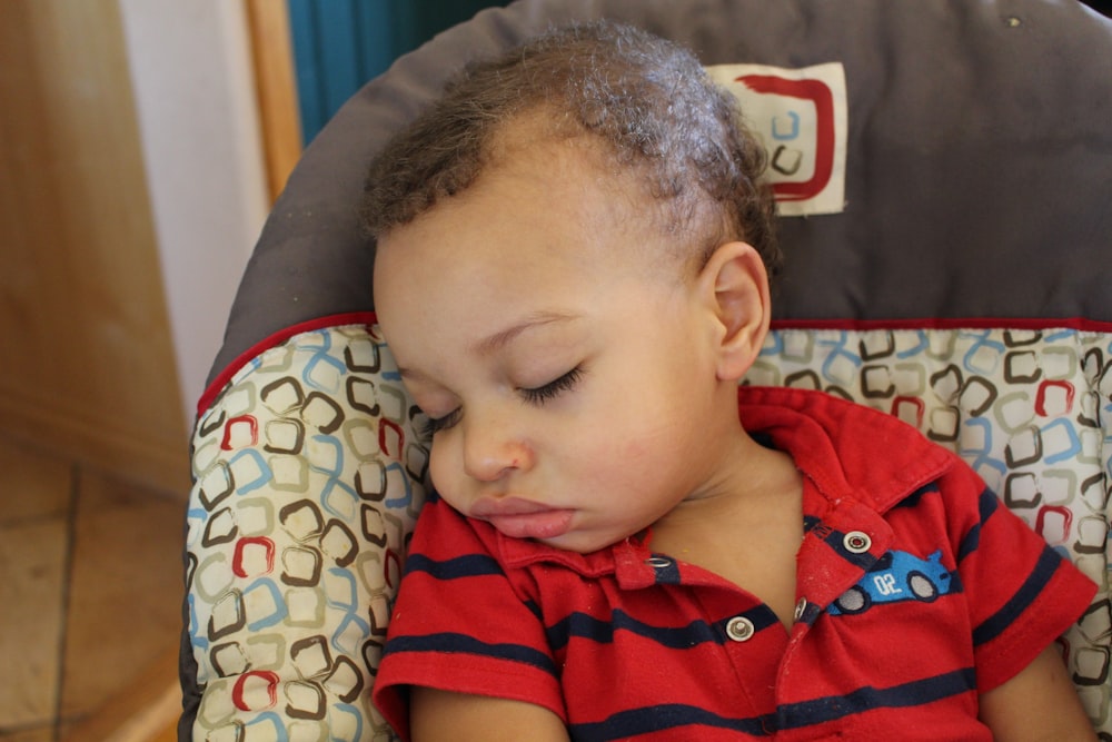 boy in red and white stripe polo shirt