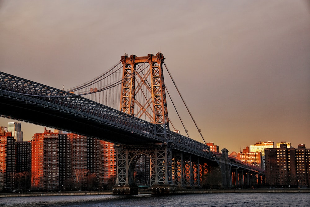 bridge over body of water during sunset