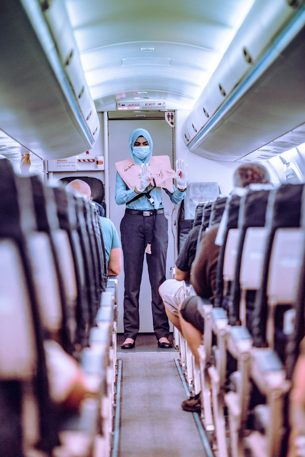 woman in blue shirt standing in train