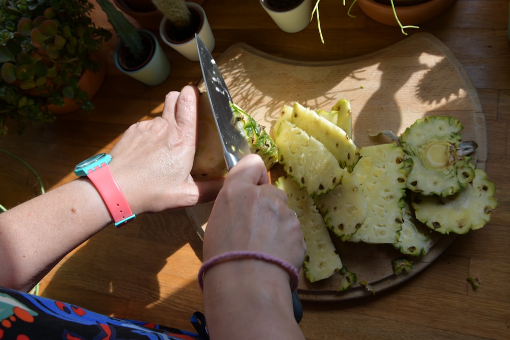 person holding stainless steel bread knife