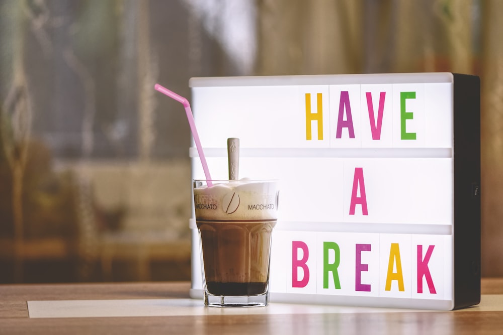 white and brown plastic cup with pink straw